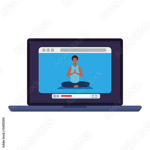 online, yoga concept, man afro practices yoga and meditation, watching a broadcast on a laptop computer