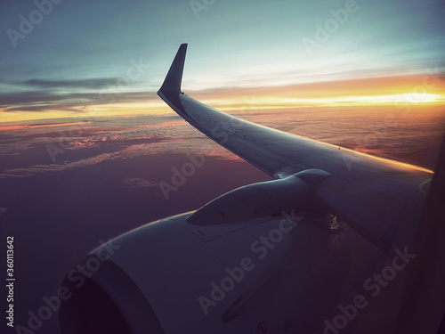 retro vintage style above cloud sky view with strong sunlight on evening sunset environment photo from airplane window
