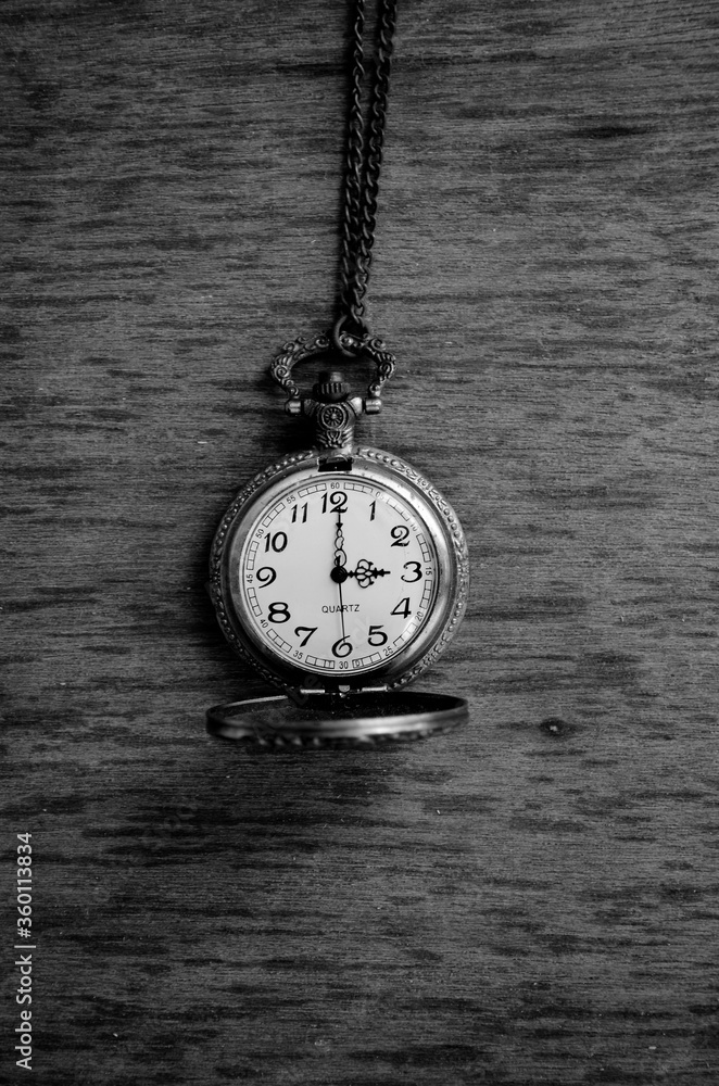Dhaka, Bangladesh - April 25, 2020: A fashionable pocket watch with a golden chain in black background. Happy home photography during the quarantine. Stay home, stay safe. Dhaka, Bangladesh - April 25, 2020: A fashionable pocket watch with a golden chain in black background. Happy home photography during the quarantine. Stay home, stay safe.