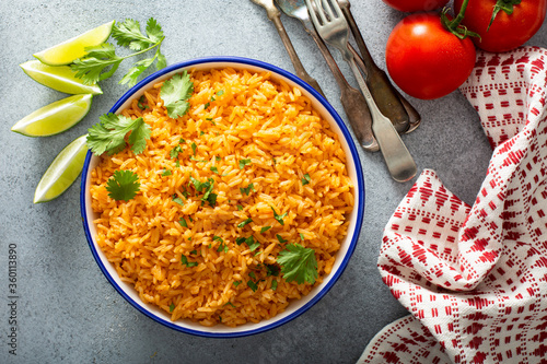 Mexican rice with tomatoes and onion served with cilantro