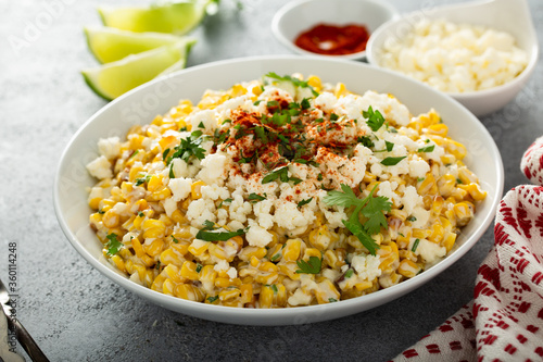 Mexican street corn, elote with cotija cheese, fresh cilantro and chili photo