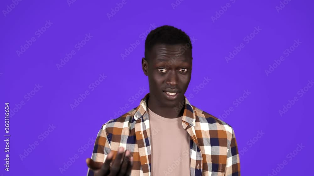 Cheerful man in plaid shirt inviting, waving hands, Offering to Join. Young Black Man Gesture over blue background Cheerful man in plaid shirt inviting, waving hands, Offering to Join. Young Black Man Gesture over blue background