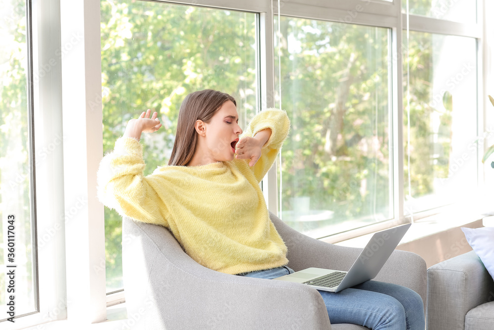Young woman suffering from sleep deprivation with laptop at home Young woman suffering from sleep deprivation with laptop at home