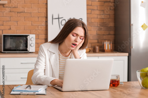 Tired woman working at home...
