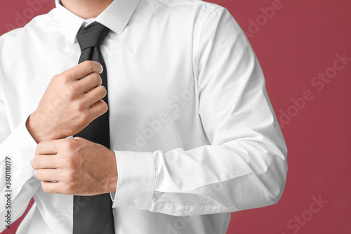 Young businessman in stylish shirt on color background, closeup
