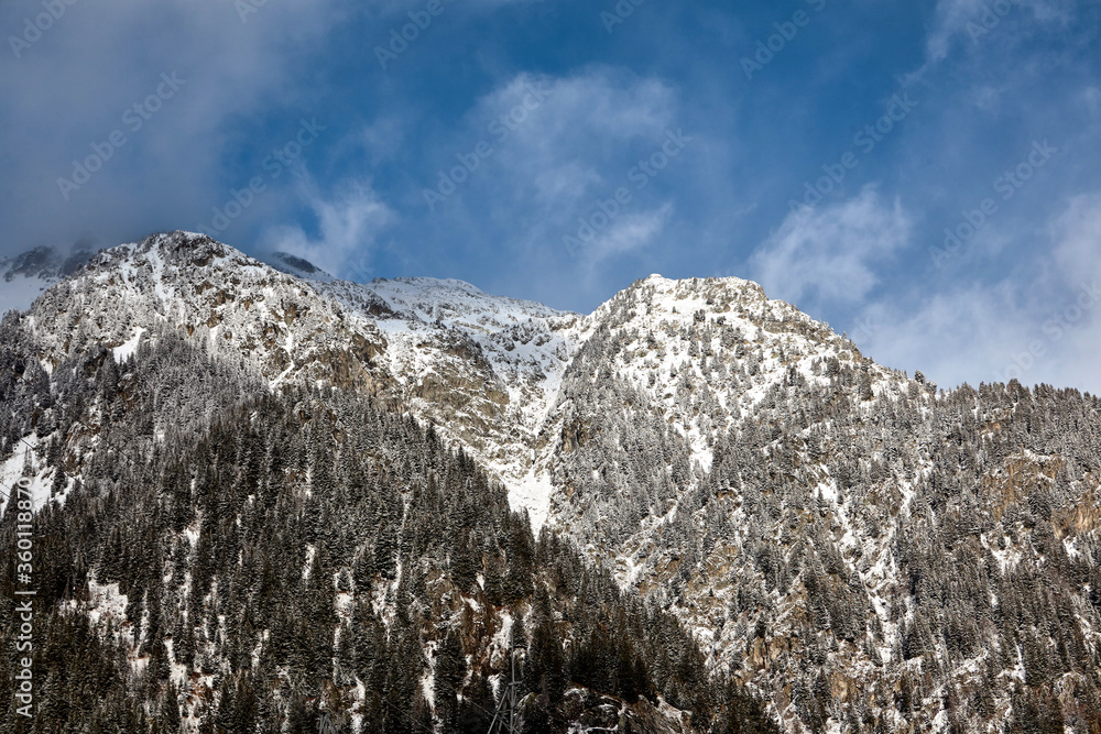 Snowy mountains on blue sky background Snowy mountains on blue sky background