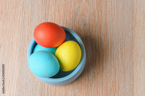 Colorful Easter eggs in a blue bowl. Easter eggs are a symbol and a mandatory attribute of Easter.