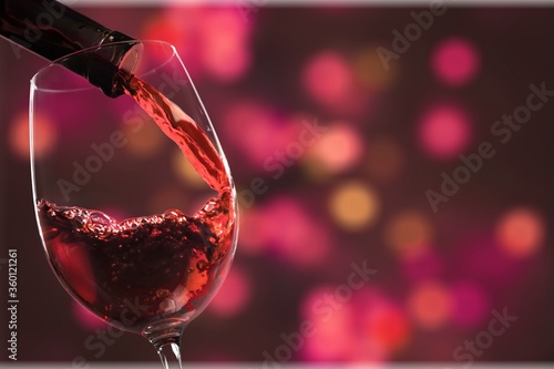 Red wine and glass on bokeh background