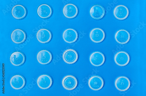 transparent white round caps on a blue background. pattern
