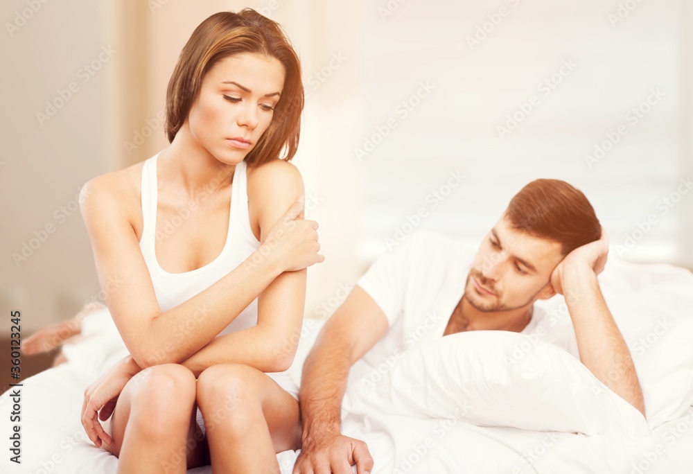 Beautiful young woman in bed. Sex problems concept Beautiful young woman in bed. Sex problems concept
