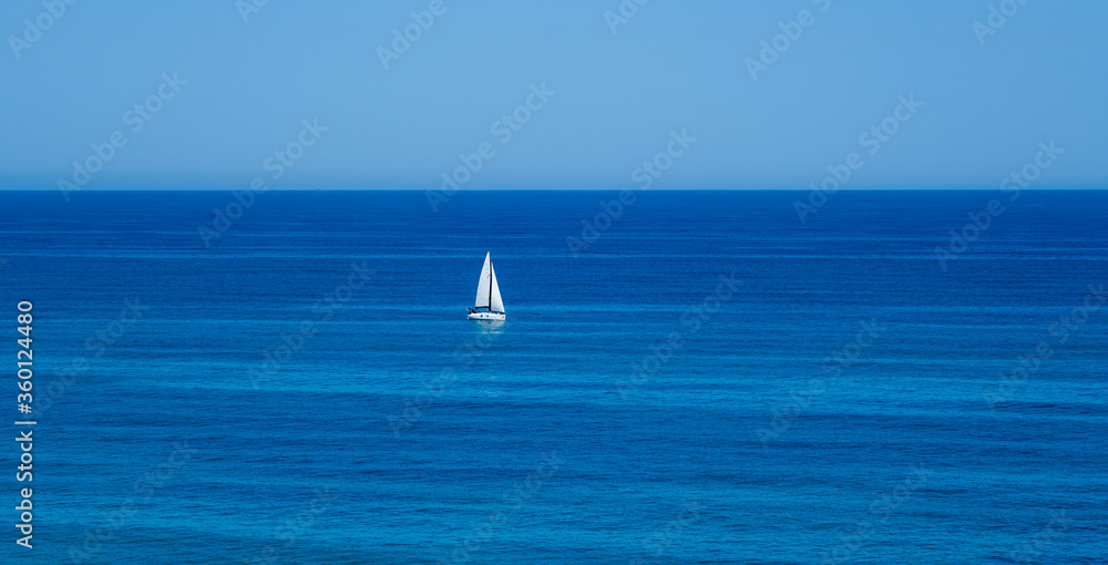 A lonely white yacht at opened sea