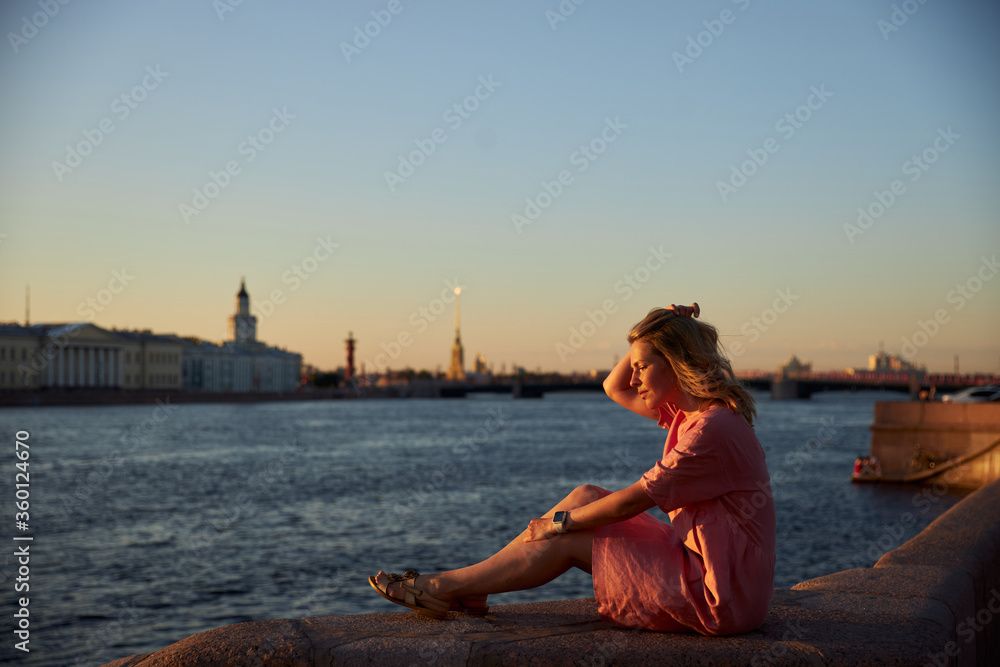young woman sitting on the pier