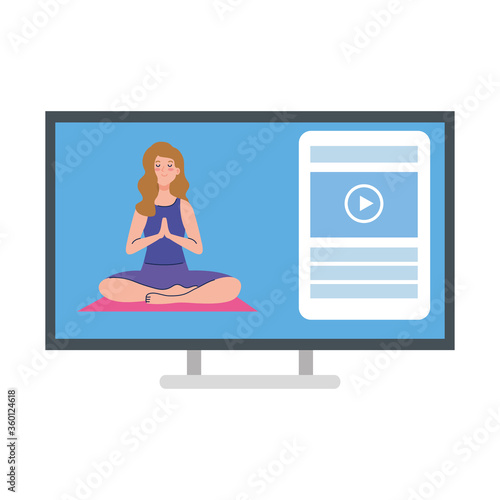 online, yoga concept, woman practices yoga and meditation, watching a broadcast on a computer