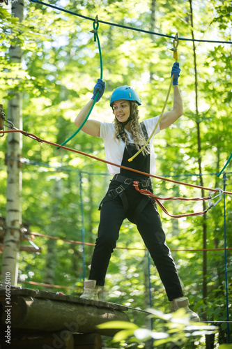 Blonde woman standing on the rope bridge entertainment in full insurance