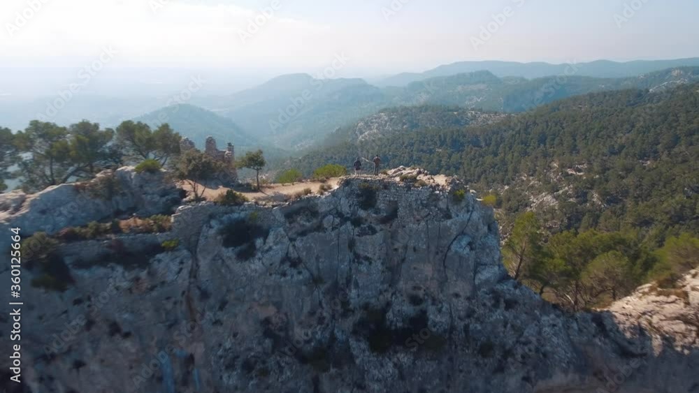 Aerial shot of two friends exploring / hiking on a mountain in the wilderness in 4k - Mallorca - Serra de Tramuntana - Balearic Islands - Europe Aerial shot of two friends exploring / hiking on a mountain in the wilderness in 4k - Mallorca - Serra de Tramuntana - Balearic Islands - Europe
