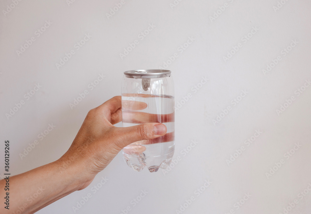 clean water in transparent can in hand clean water in transparent can in hand