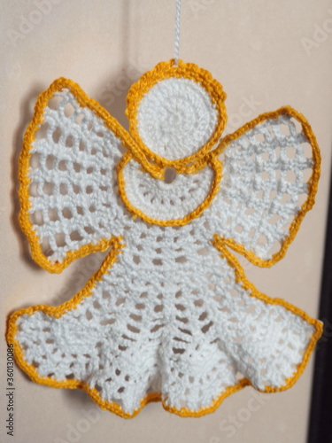 Christmas tree decoration. Crochet angel. Handmade ornament. Selective focus.