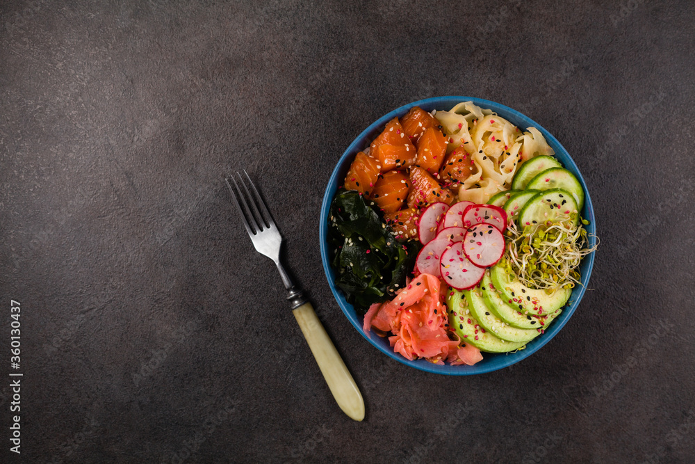 Hawaiian salmon poke bowl with seaweed, avocado, sesame seeds. Hawaiian salmon poke bowl with seaweed, avocado, sesame seeds.