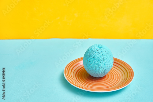 painted orange in turquoise color on an ceramic plate. creativity design concept