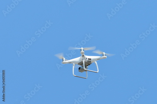 Flying unmanned quadcopter drone with video camera