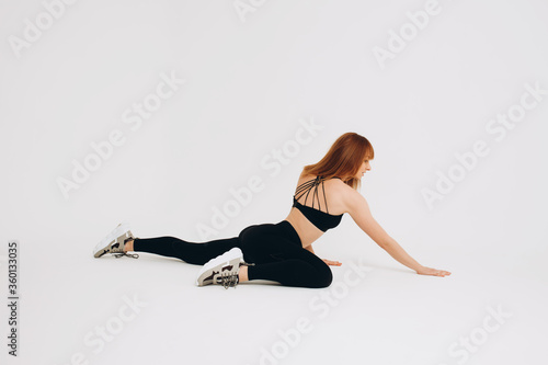 Side view of female athlete stretching leg quadriceps muscles while warming up. Full body length portrait isolated on white studio background 
