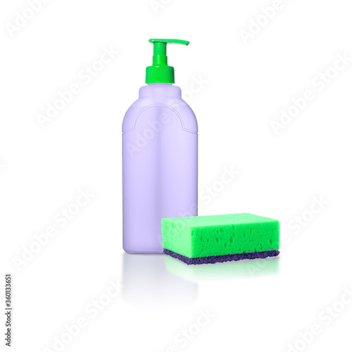 A transparent purple bottle with a green cap and purple and green sponge with reflection isolated on white background
