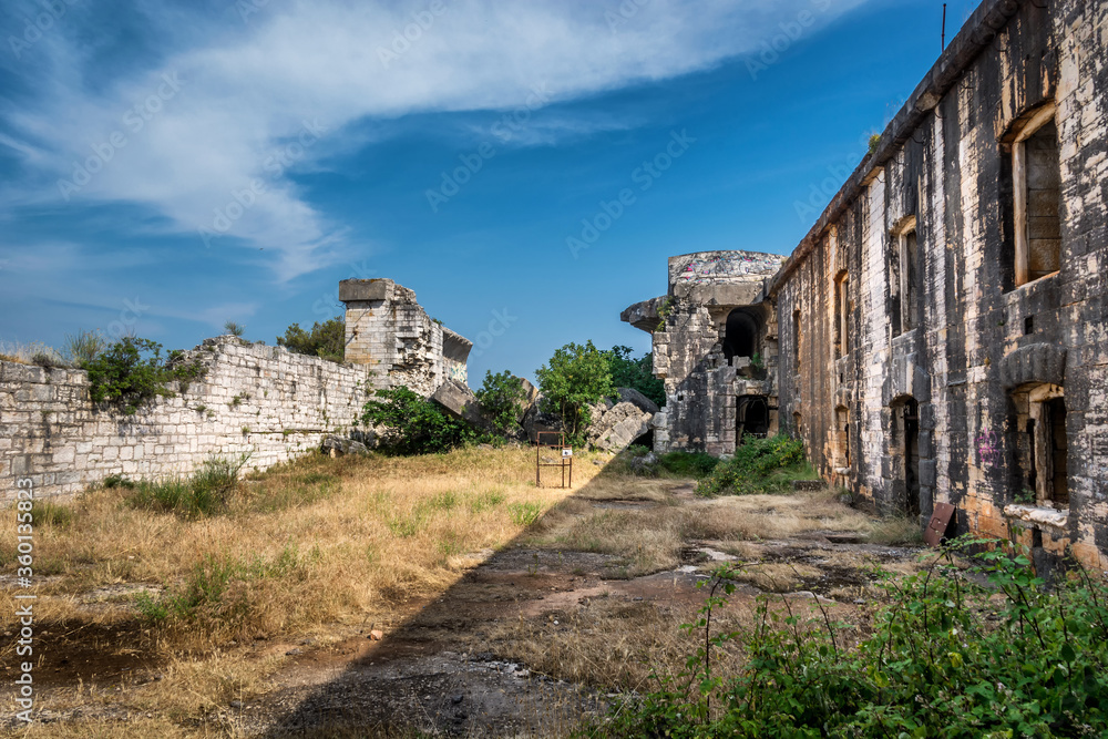 Ruins of Austro-Hungarian Fortification Fort Forno in Istra, Croatia. Beautiful historical fortress made of stone. Abandoned landmark dating back to 1904 covered with vegetation in bad shape