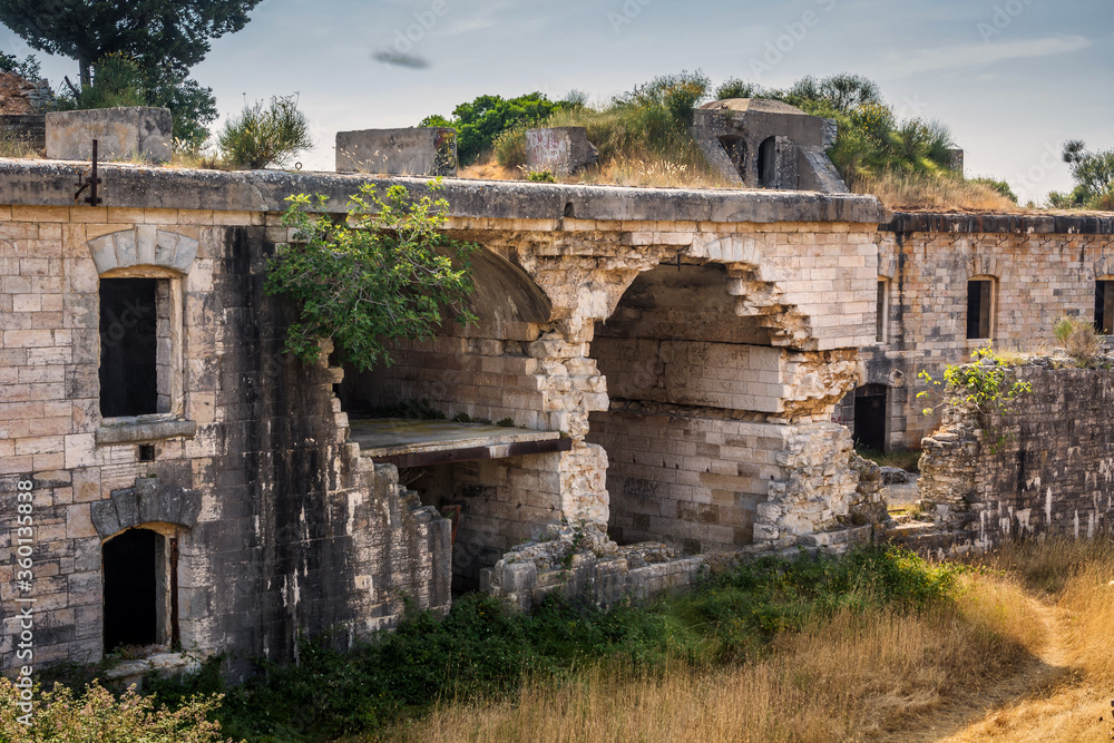 Ruins of Austro-Hungarian Fortification Fort Forno in Istra, Croatia. Beautiful historical fortress made of stone. Abandoned landmark dating back to 1904 covered with vegetation in bad shape Ruins of Austro-Hungarian Fortification Fort Forno in Istra, Croatia. Beautiful historical fortress made of stone. Abandoned landmark dating back to 1904 covered with vegetation in bad shape