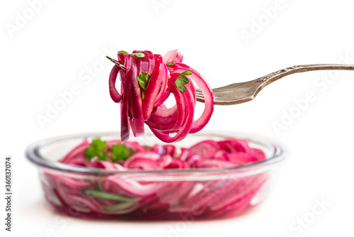 Canvas Print Marinated pickled red onion rings on fork isolated on white