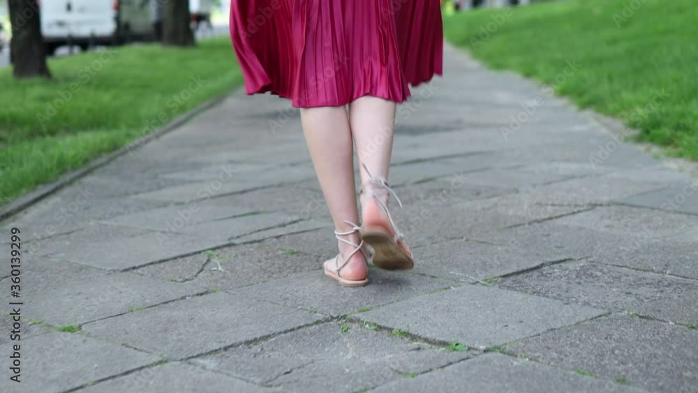 Attractive young woman walking and smiling
Attractive young woman walking and smiling