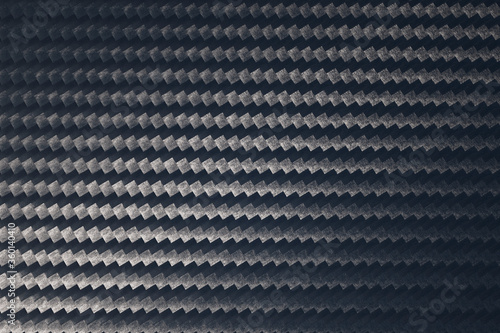 Macro photo of grey carbon fiber pattern texture.