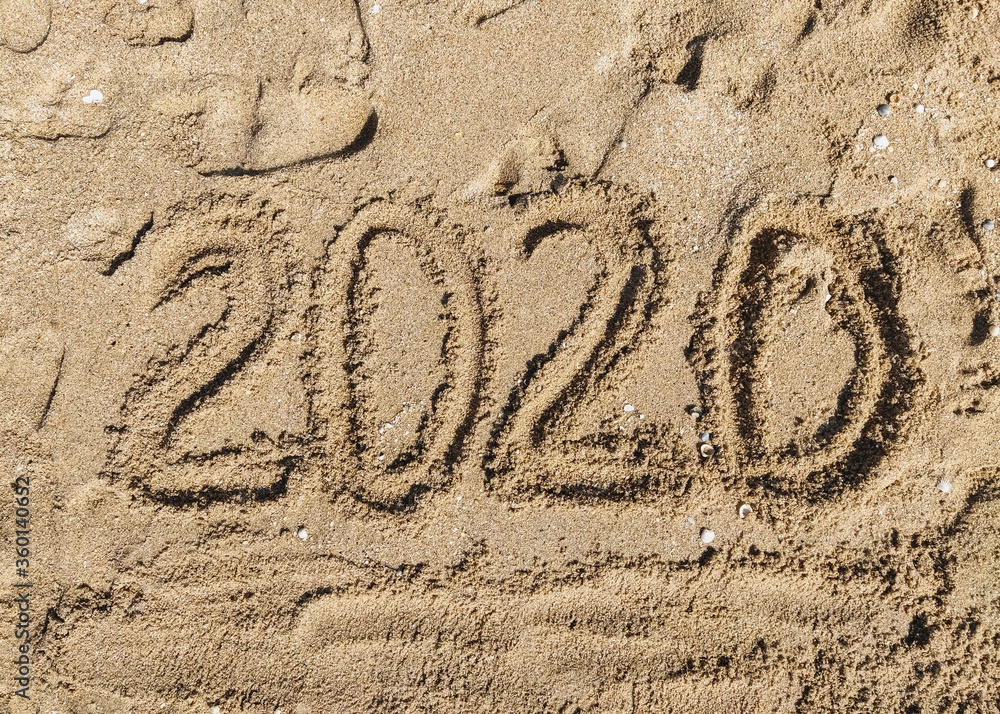 Fototapeta premium Summer, year and vacation 2020. The inscription, the words written in the sea sand. Photograph, copy space.