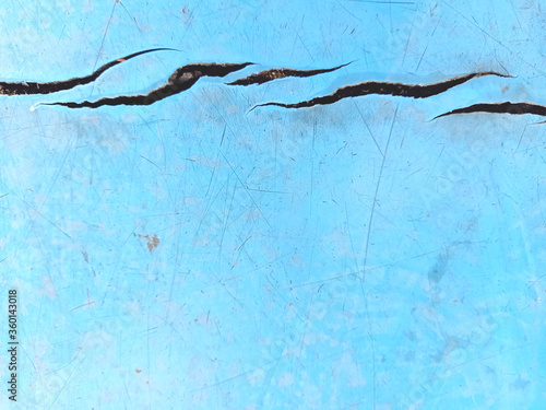 Cracks of the blue rubber flooring in the pool