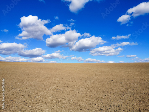 Spring plowed field with beautiful blue sky