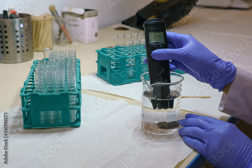 Digital water test in girl hand, water analysis technology.  Digital pH Meter Probe Analysis Tester Kit Water Aquarium Hydroponic Acidity Alkalinity of Liquids Drinking