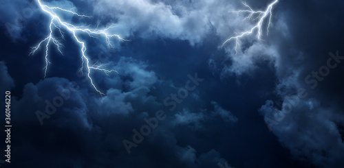 Lightning thunderstorm flash over the night sky.