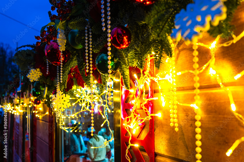 Christmas decorations and garlands on the street, illuminated winter holiday city decor