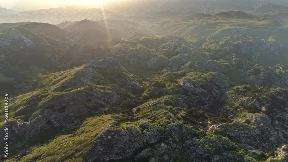 Durmitor National Park, Montenegro. Wonderful morning sunrise in Dinaric Alps. Sun rising above mountains covered with grass and moss. Aerial shot, 4K Durmitor National Park, Montenegro. Wonderful morning sunrise in Dinaric Alps. Sun rising above mountains covered with grass and moss. Aerial shot, 4K