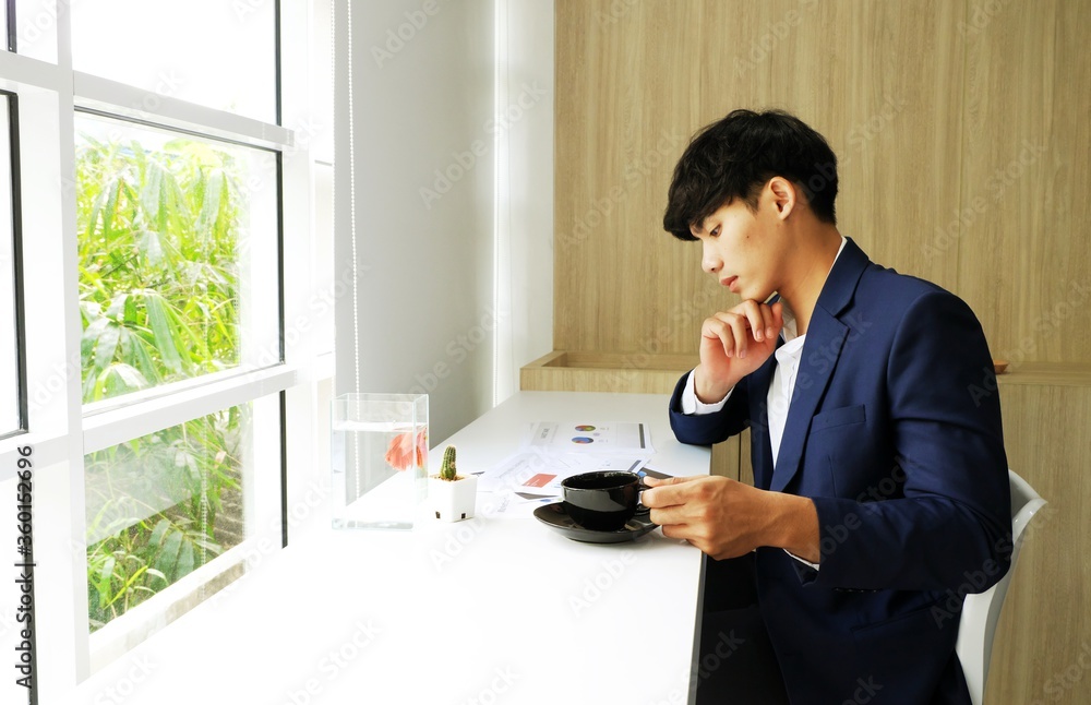 Asian Business activities at work while sipping coffee. Asian Business activities at work while sipping coffee.