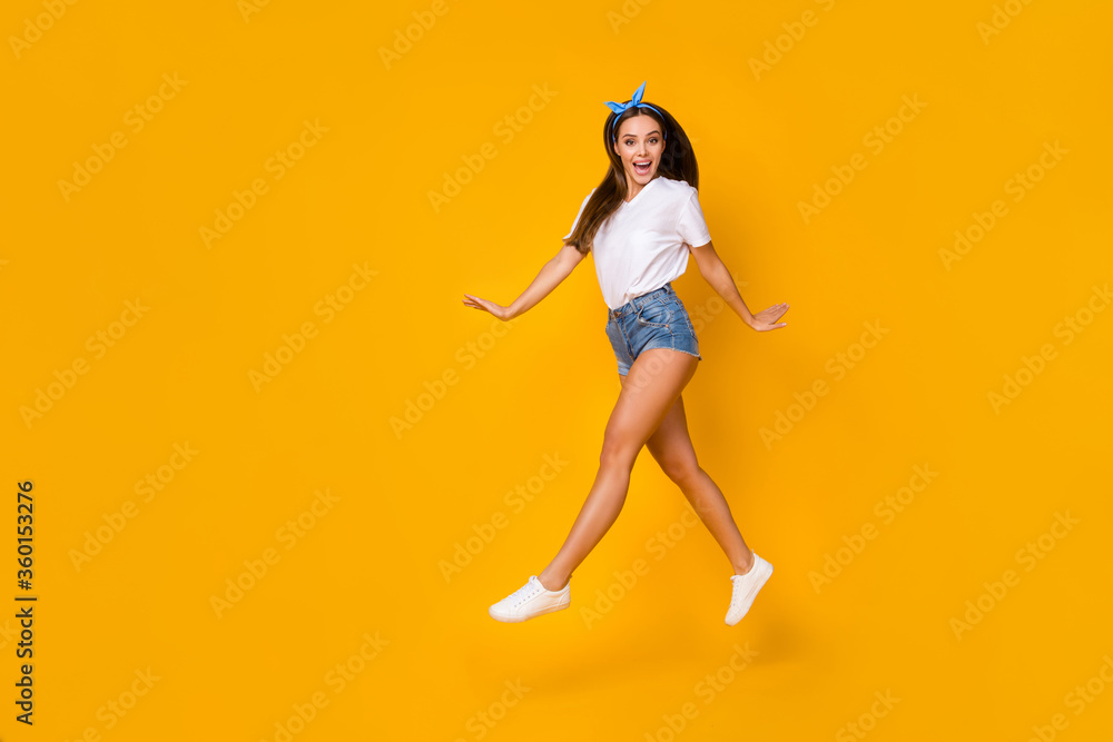 Full body photo of excited crazy carefree youth girl jump enjoy spring free time holiday wear white blue headband isolated over bright color background