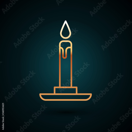 Gold line Burning candle in candlestick icon isolated on dark blue background. Cylindrical candle stick with burning flame. Vector Illustration.