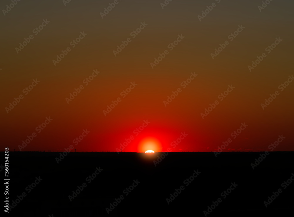 Burning sunset illuminating the horizon line background