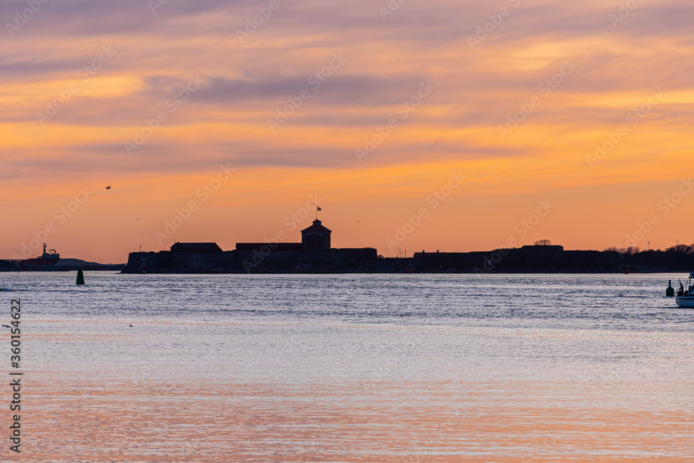 Solhouette of an old coastal fort at sunset.
