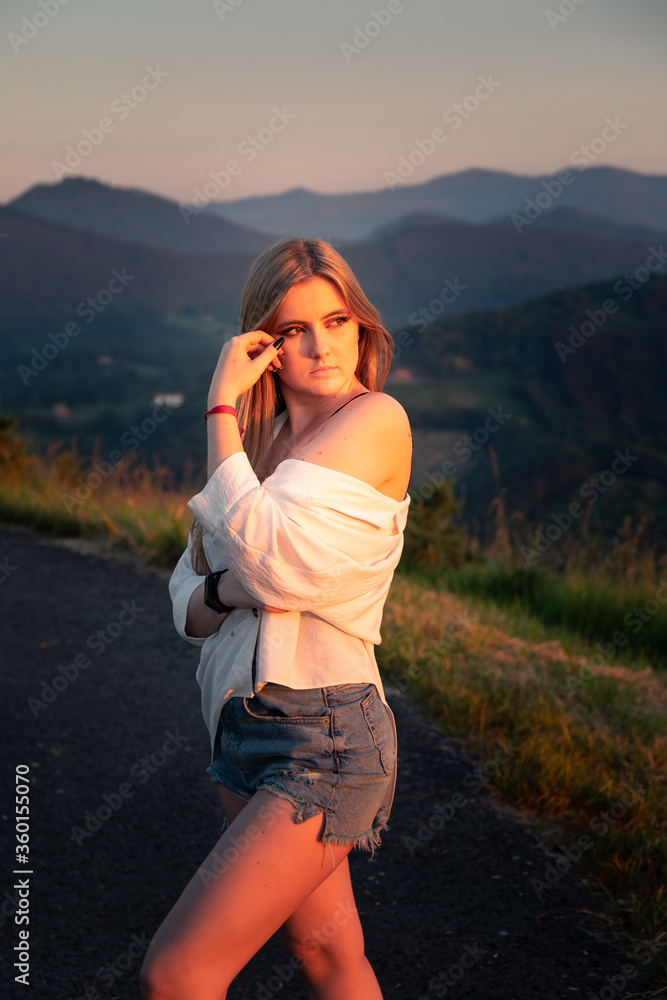 Young girl posing while being illuminated by the sunset light.