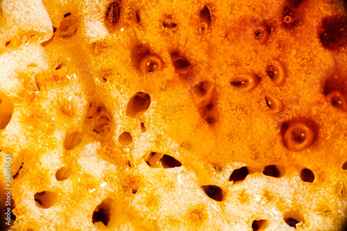 Macro photo of a toasted crumpet with honey