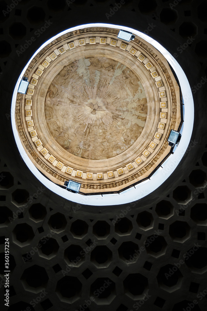 Ceiling under the dome of a Roman church with an engraved bird in the center in Rome