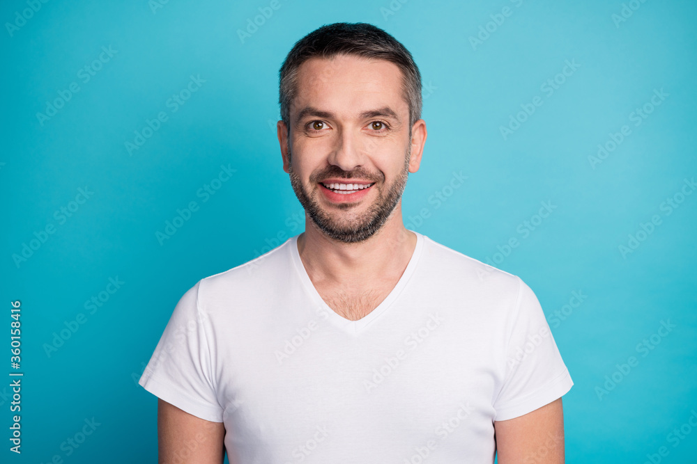Fototapeta premium Close-up portrait of his he nice attractive content cheerful cheery bearded guy wearing tshirt beaming smile isolated over bright vivid shine vibrant blue color background