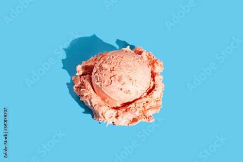 Pink sweet cherry-berry scoop ice cream on light blue background. Summer pattern, flat lay.
