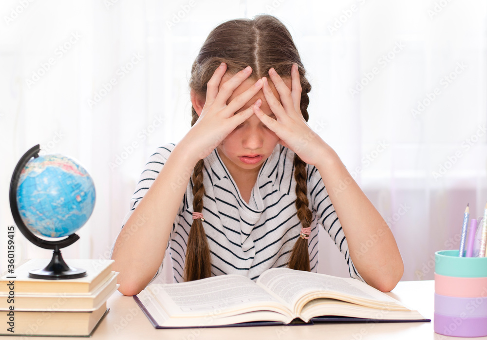 Education concept. Little cute girl child is bored and tired to study Education concept. Little cute girl child is bored and tired to study
