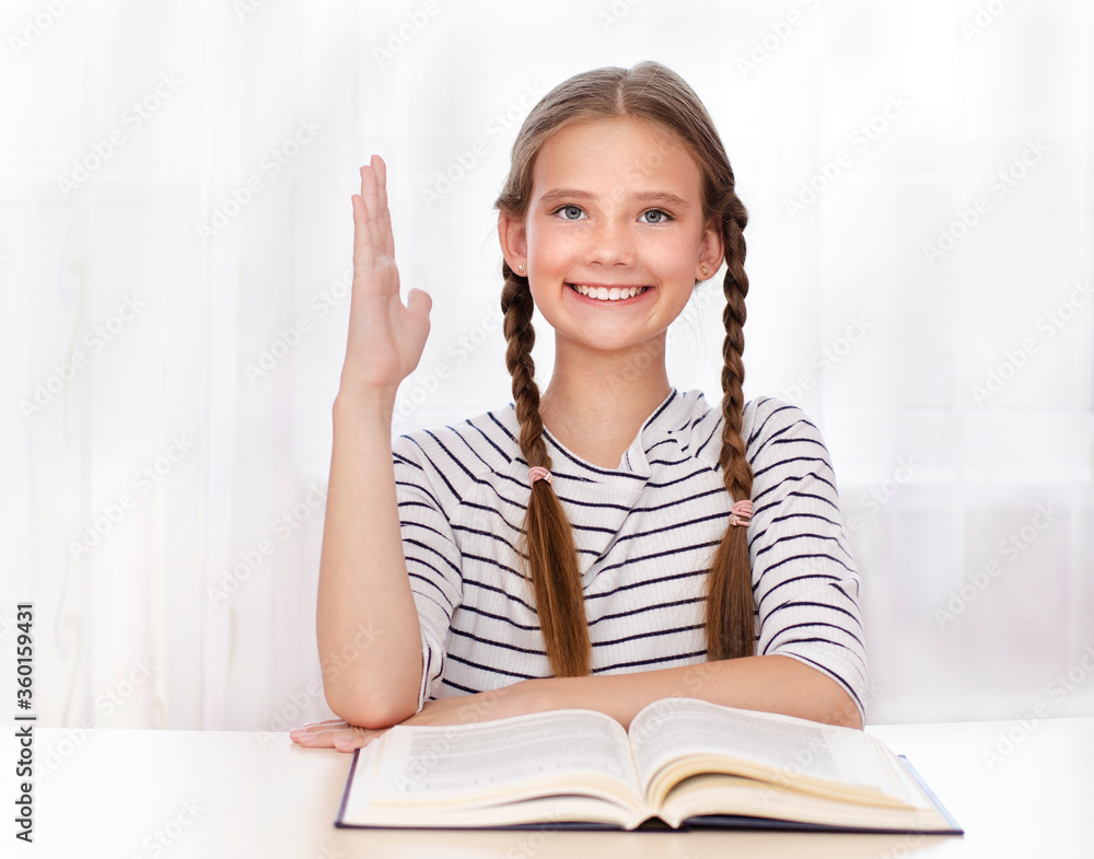 Education and school concept. Cute little student girl studying and raising hand Education and school concept. Cute little student girl studying and raising hand